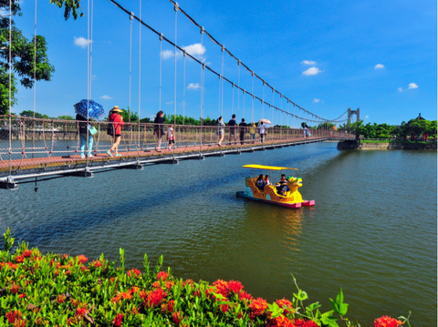 "Visitors walk on Hutoupi’s flyover to admire the lake and water"