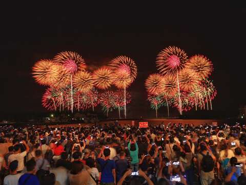 "People scramble to photograph the moment when the fireworks bloom"