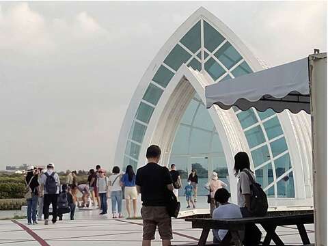 "Visitors line up to take pictures at the Crystal Church in front of the North Gate Visitor Center"