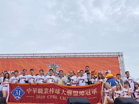 "A group photo of the team presenting the Champions Cup"