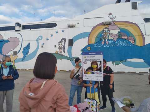 "The first batch of visiting cruise passengers take photos"