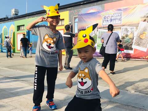 "Children wear Pikachu paper hats"